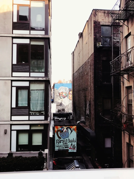 a narrow alley in a city with signs and buildings