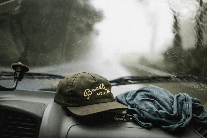 a baseball cap that says sophos is sitting on a car dashboard