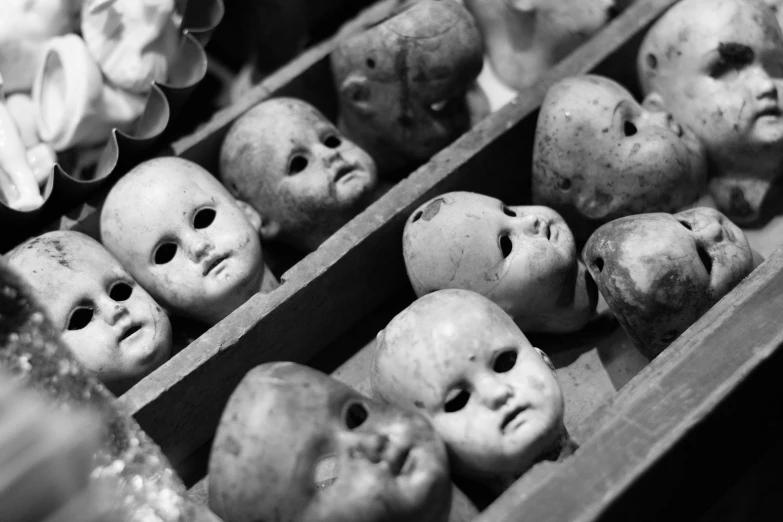 a number of old looking dolls in a box
