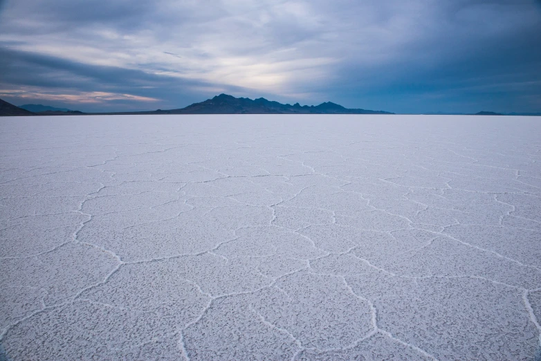 white snow covers the ground and mountains in distance