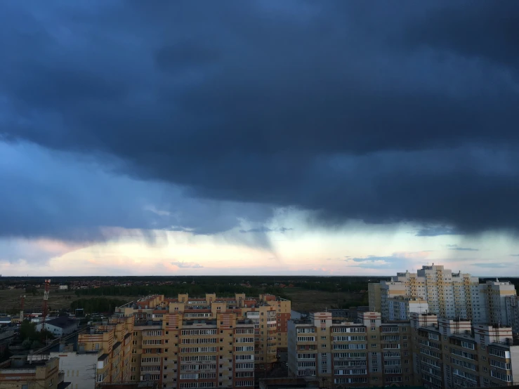 a cloudy sky with some building in the background