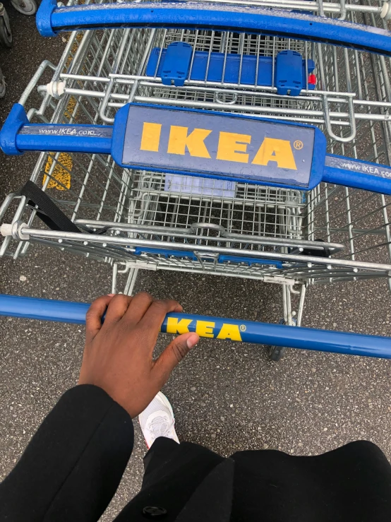 two people putting letters on top of a shopping cart