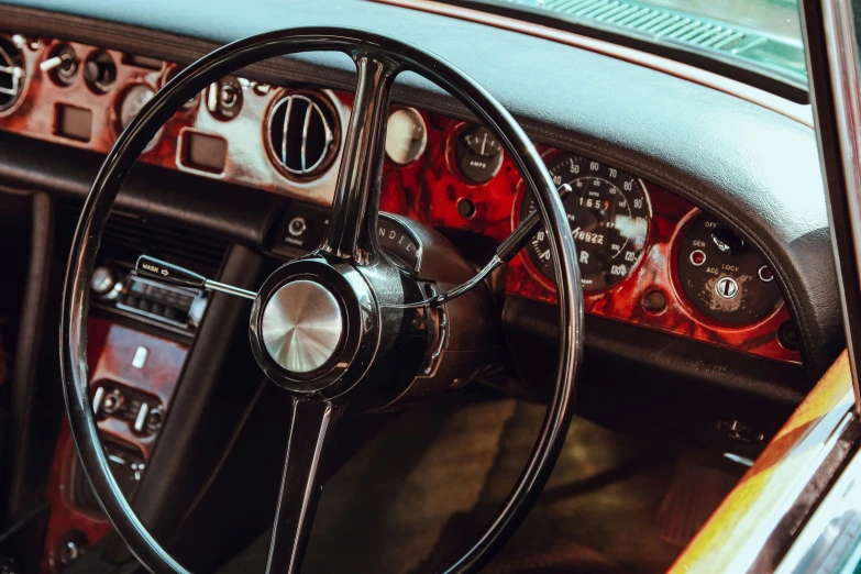 dashboard of an old car with the steering wheel and dash board visible