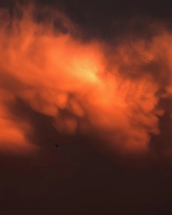 an airplane flying across a sky filled with clouds