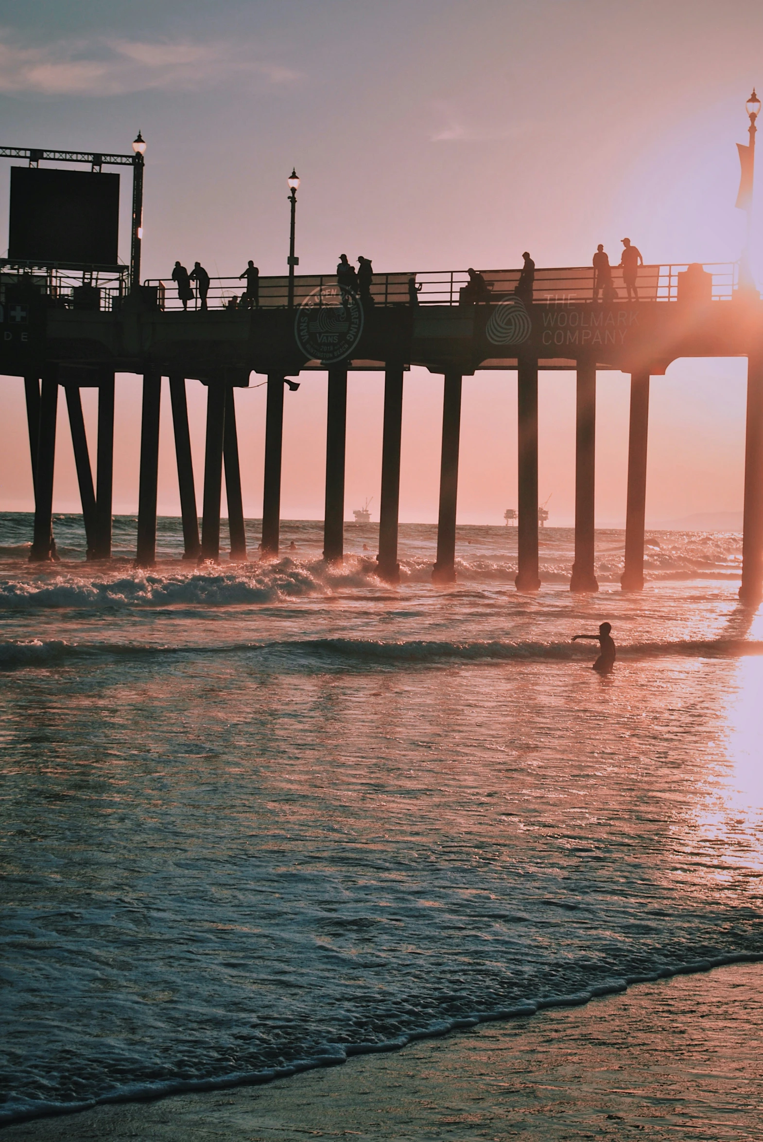 people standing on the end of a pier