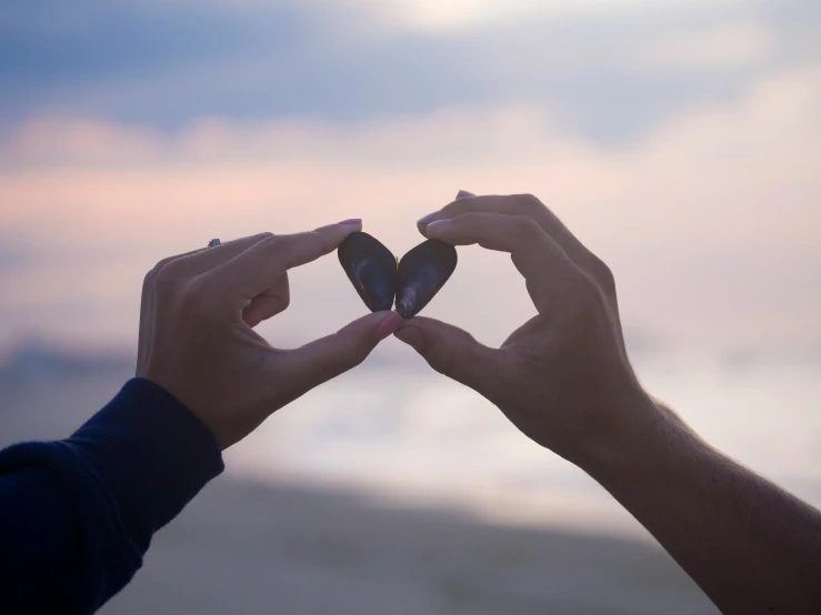 two hands that are holding some kind of object