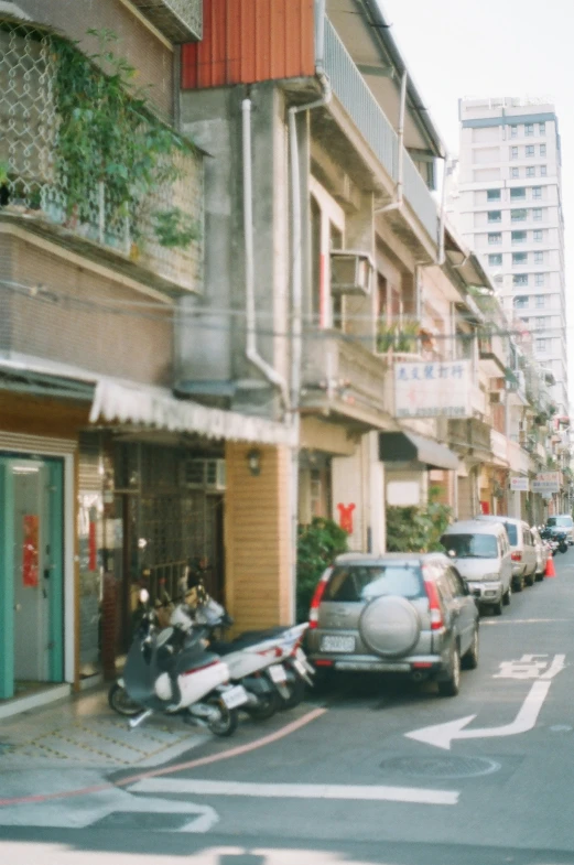 a car on the side of a street with people in the middle of it