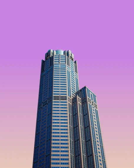 an unusual po of some tall buildings in front of a pink sky