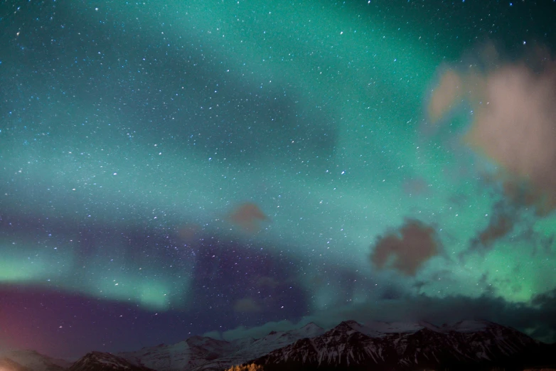 a man sits in a tent with the stars above them, watching the sky