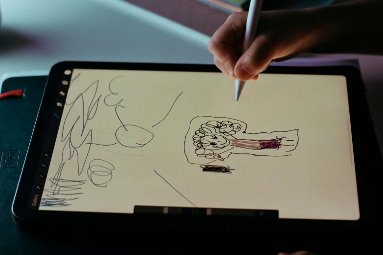 someone is drawing on an ipad screen and using a pen