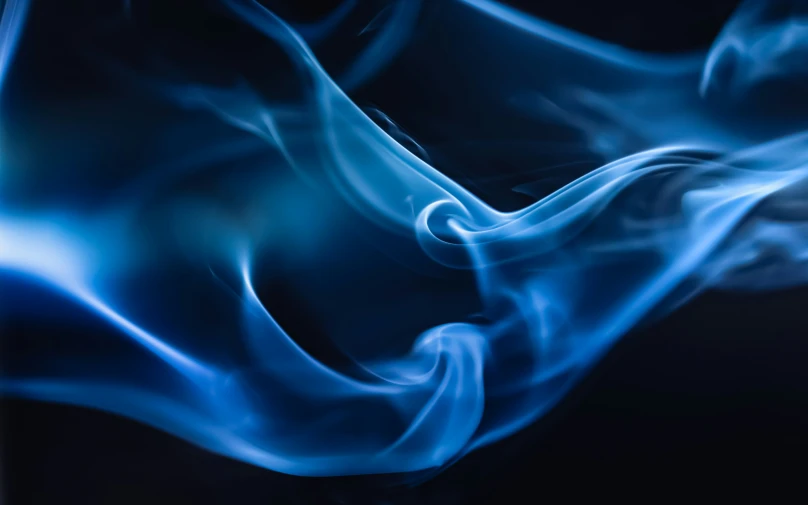 a dark background with blue fire in it