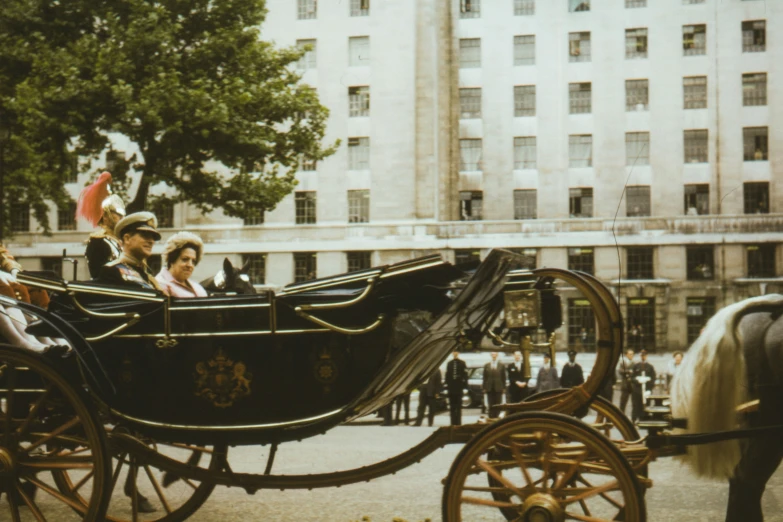 a horse drawn carriage with people riding in it