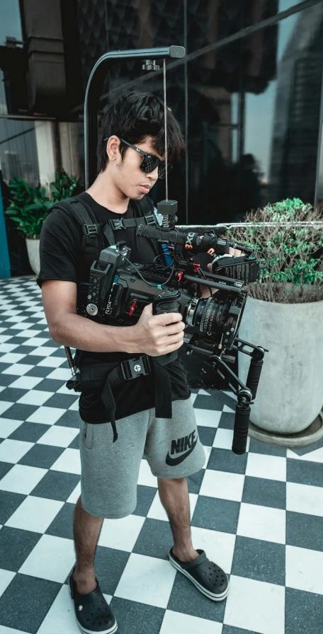 a man standing with a camera in his hands