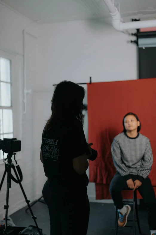 two people sitting in chairs near each other