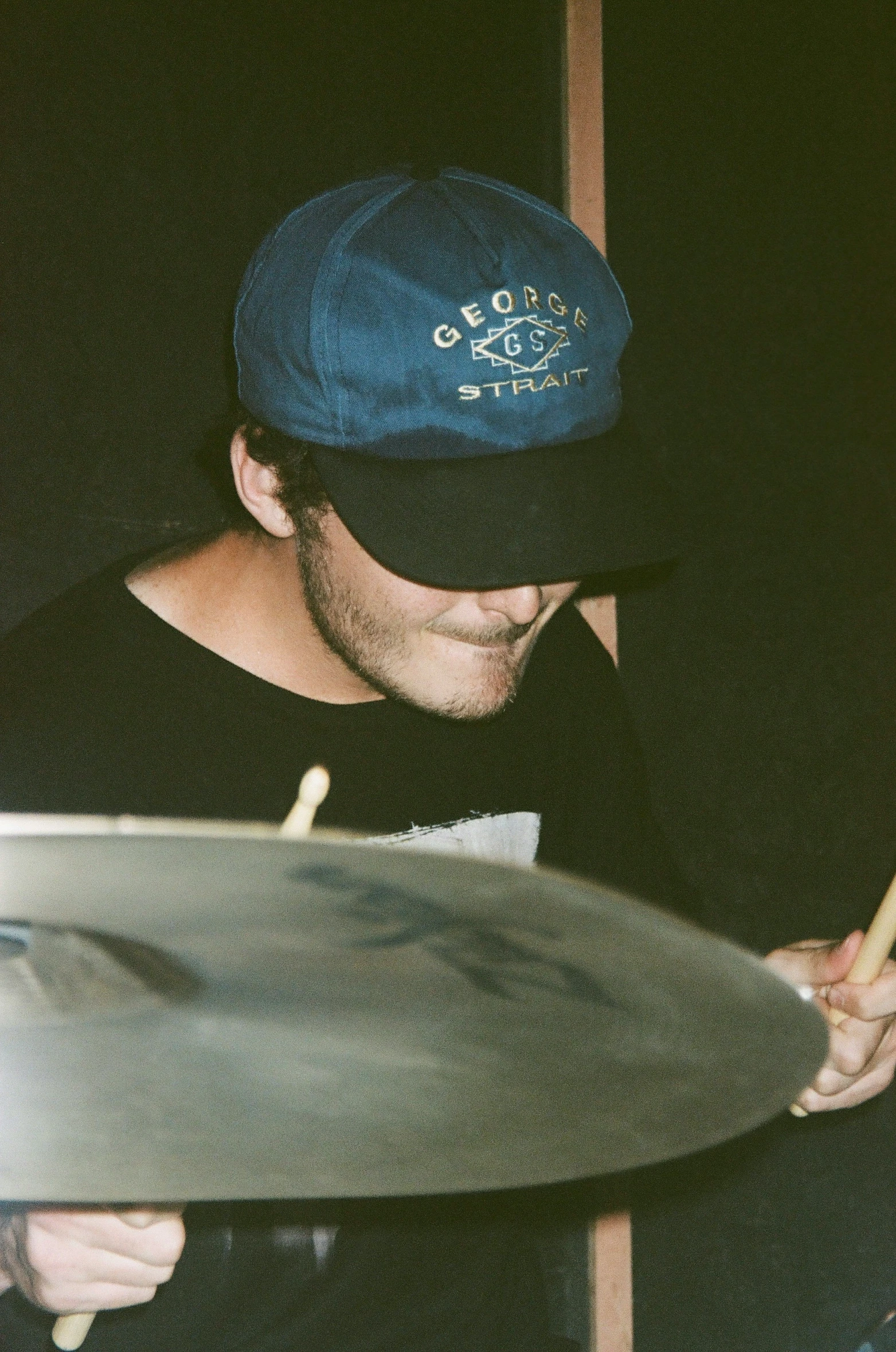 a man playing a drum in a room