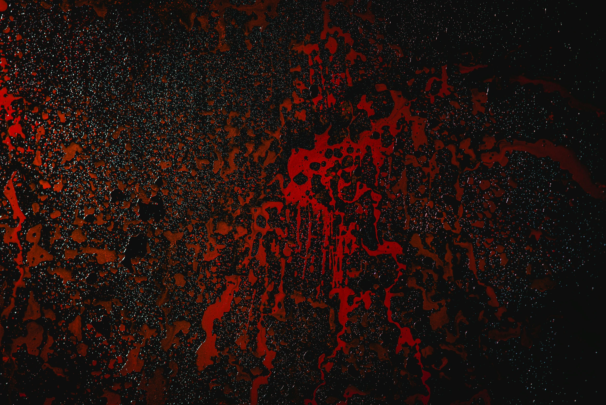 some red paint splashes on a black background