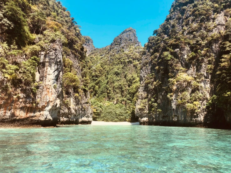 a lake surrounded by mountains and trees next to water