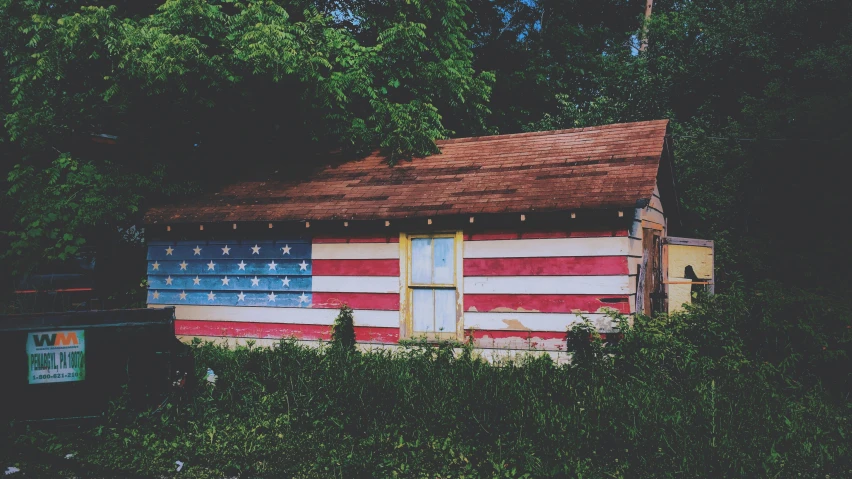 a log house with an american flag painted on it