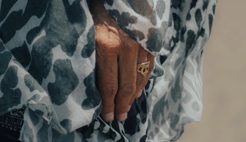 a person with their hand on a patterned material