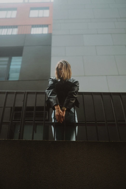 a couple on a balcony holding hands