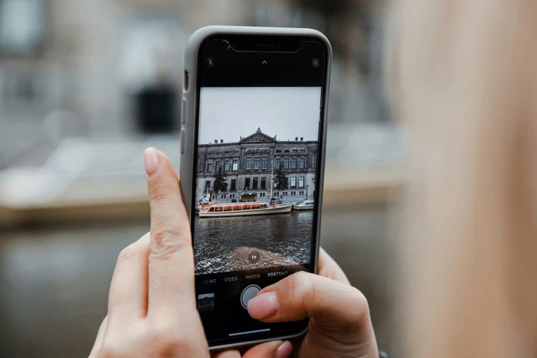 someone taking a picture of a big building