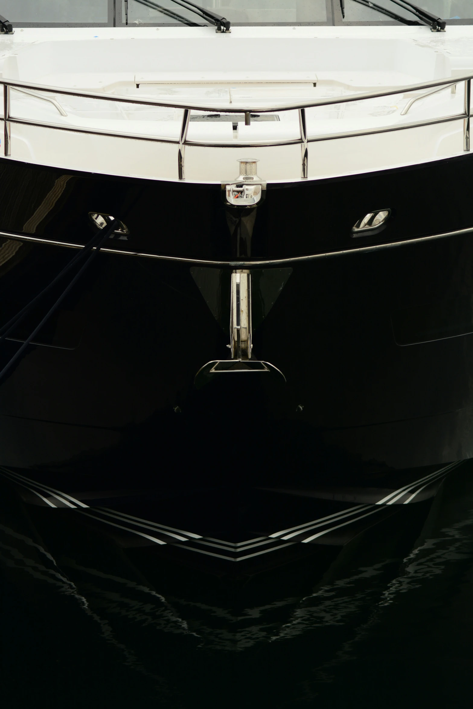 a white and black boat is docked at a dock