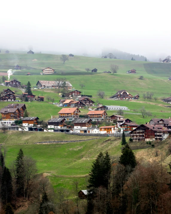 a village on a hillside covered in fog