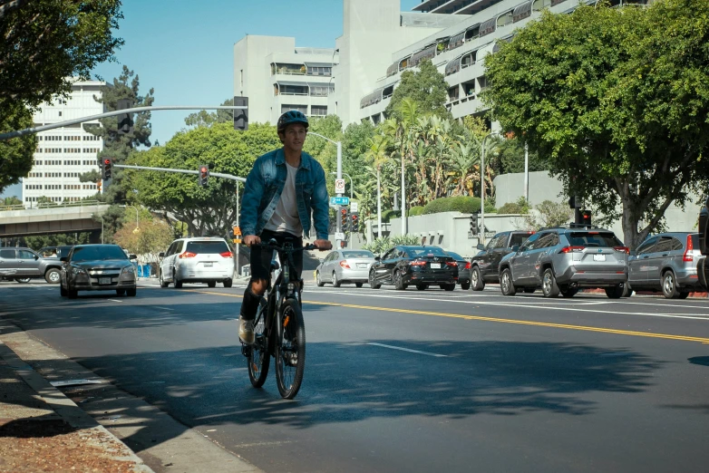 a man rides his bike down the street