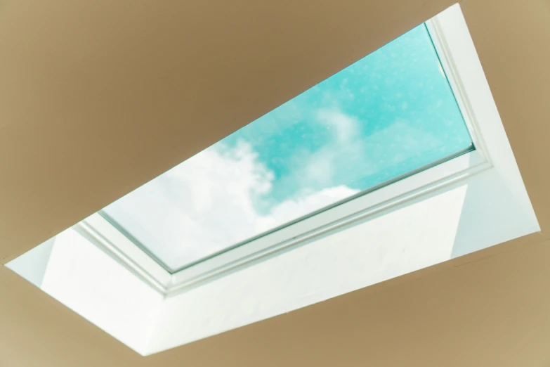 there is a skylight with a cloudy blue sky in the background