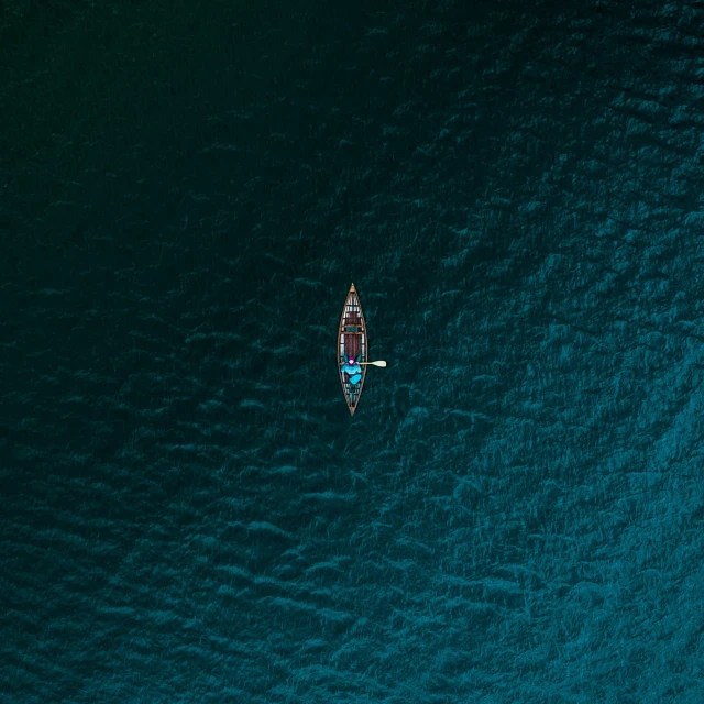 a couple of boats floating next to each other on a body of water