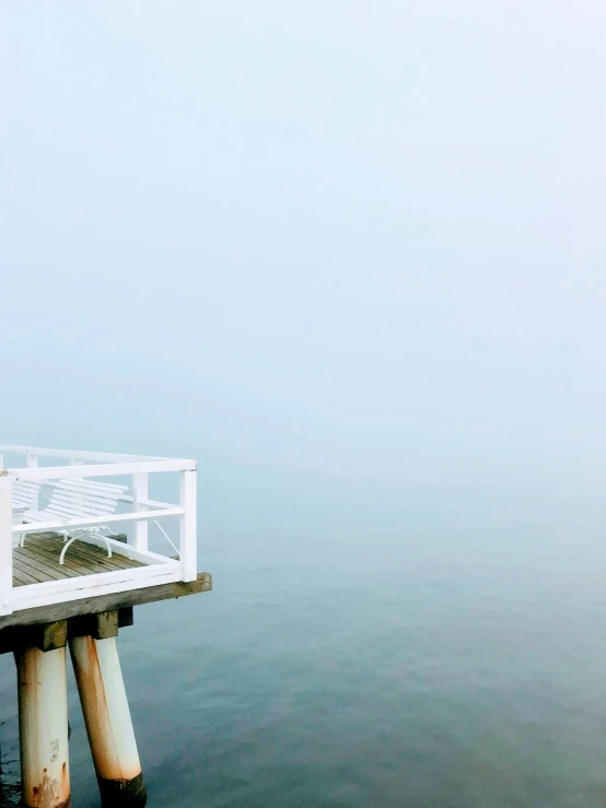 a person walking on a bridge over water