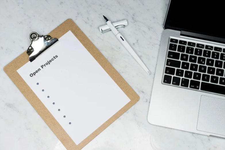 the keyboard has a clipboard with a pen on it next to it