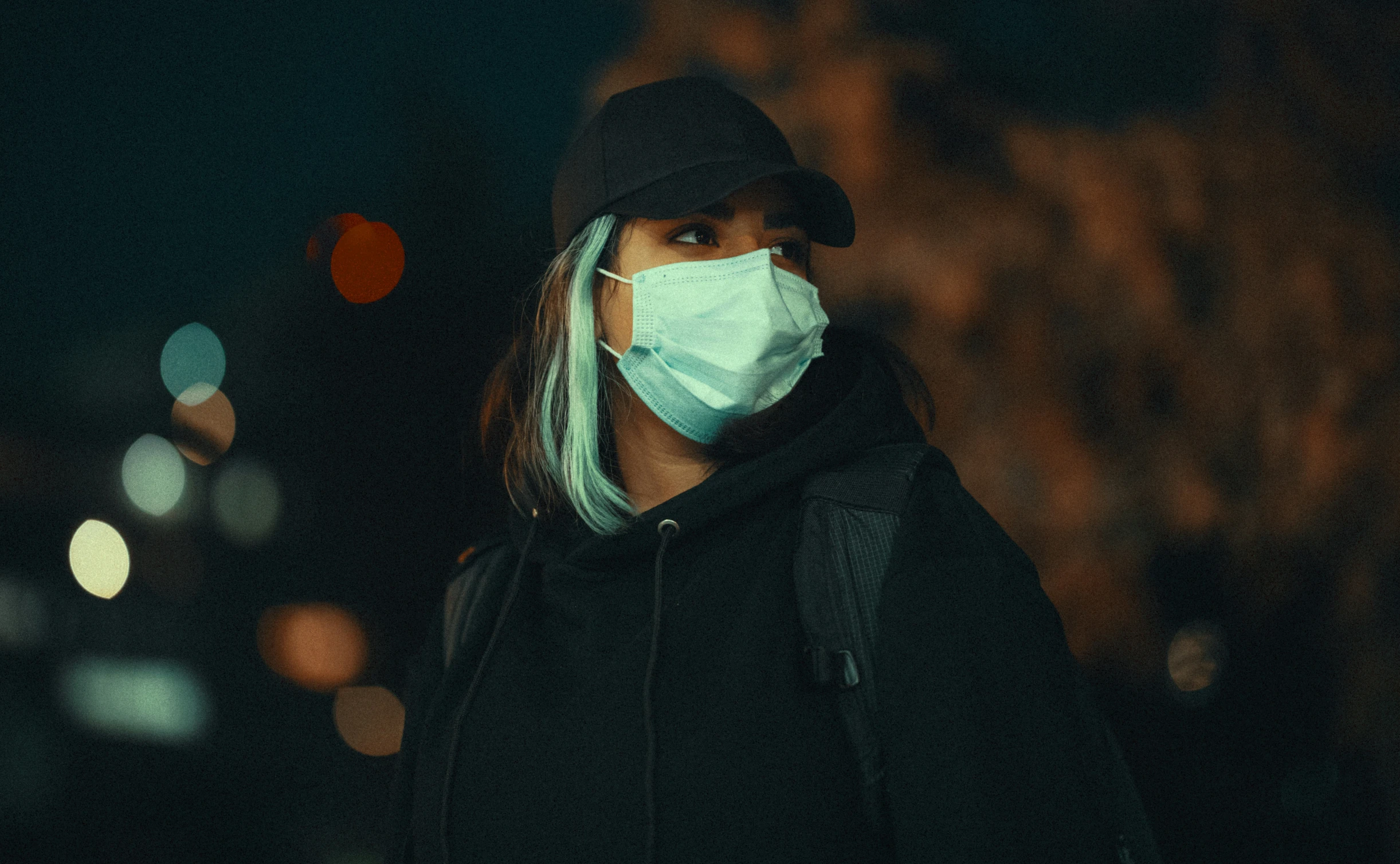 a person wearing a mask in a dark room