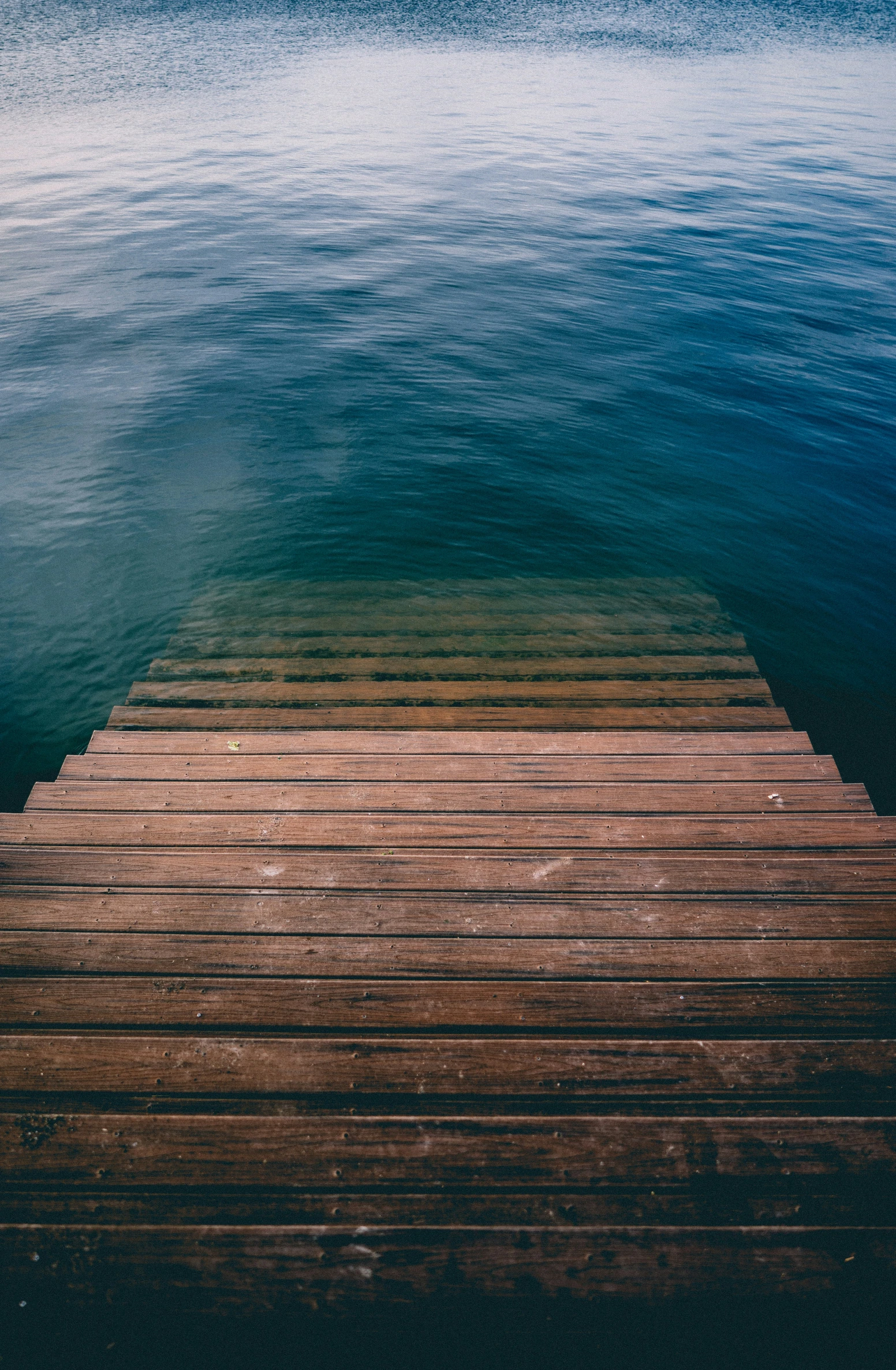 a wooden dock leading out to some water