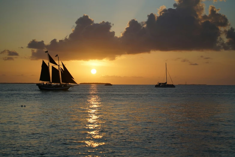 some small sail boats in the water