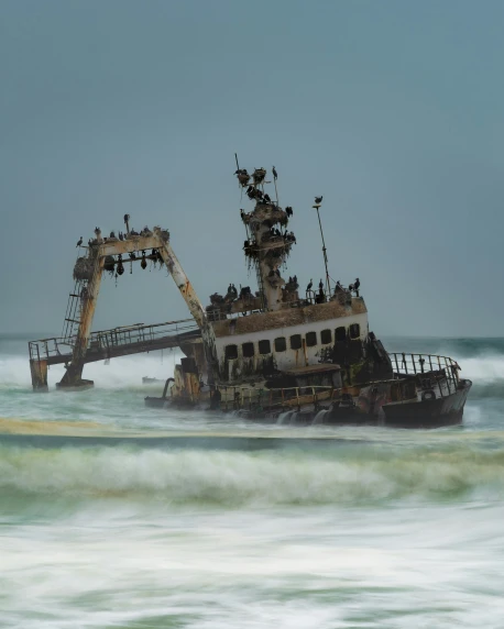 a boat that has been washed ashore on the ocean