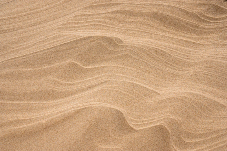 a sandy area with lines and patterns that are drawn on it