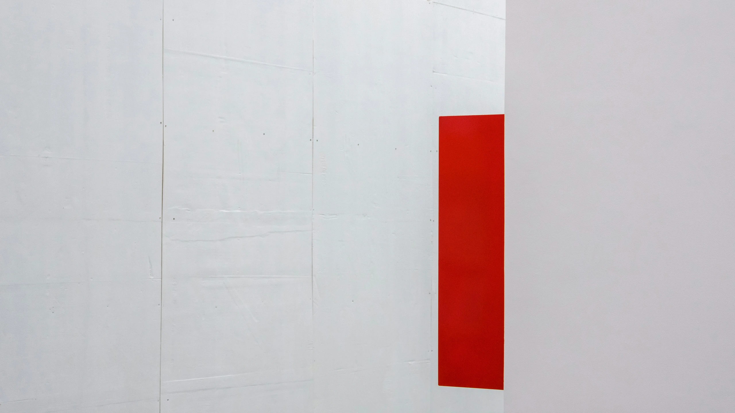 a red and white wall with two orange lines