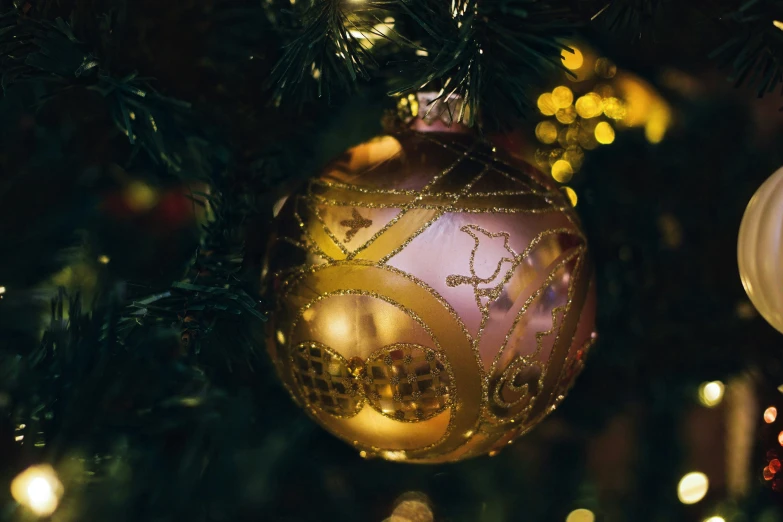 christmas decorations are hanging from a tree