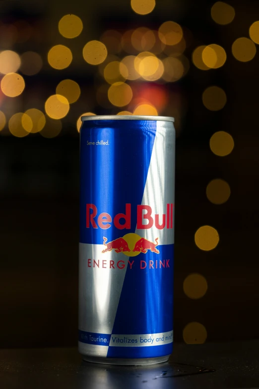 a can of red bull energy drink sits on a table
