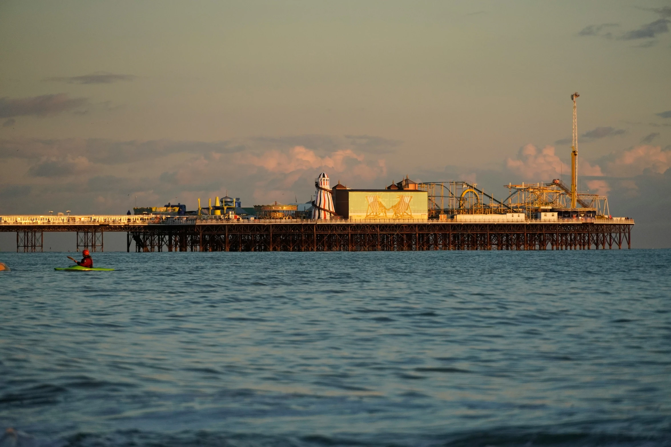 a long pier with many boats near it