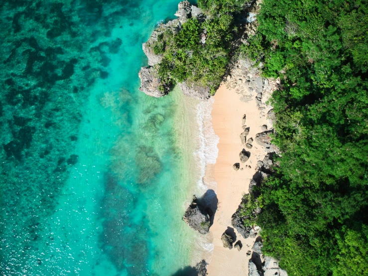 an aerial s of an ocean, beach and rocky shore