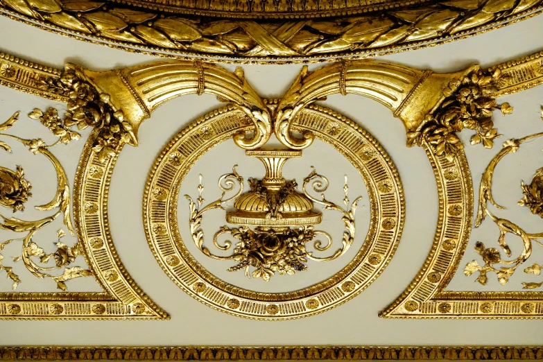 gold ornate decoration is being displayed in the ceiling