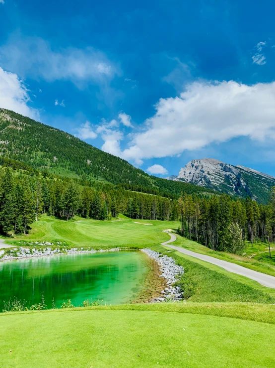 a golf field with mountains in the distance