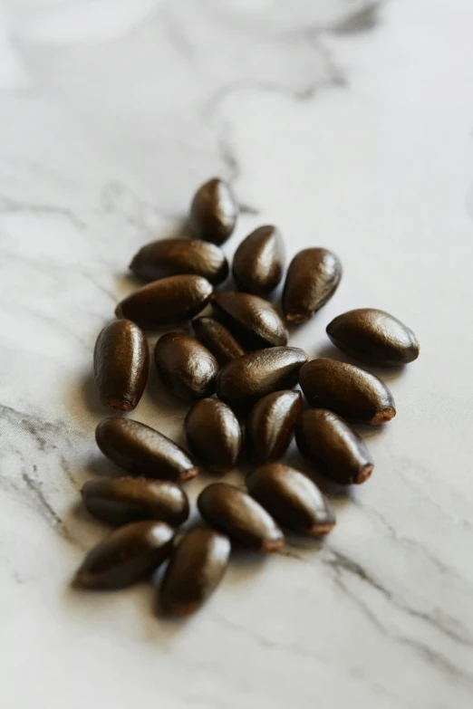 coffee beans are on a white marble counter