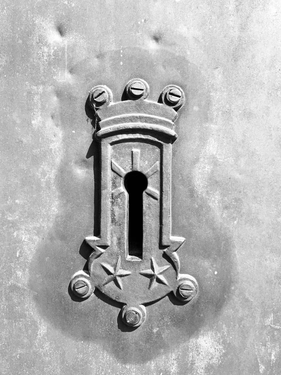 a castle emblem on the wall and above it are three small balls