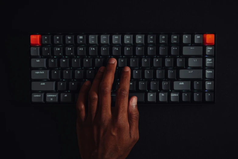 a close up view of a person's hand pressing a on on a keyboard