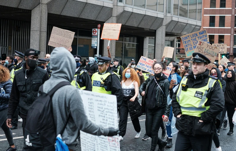 a crowd of police are walking down the street