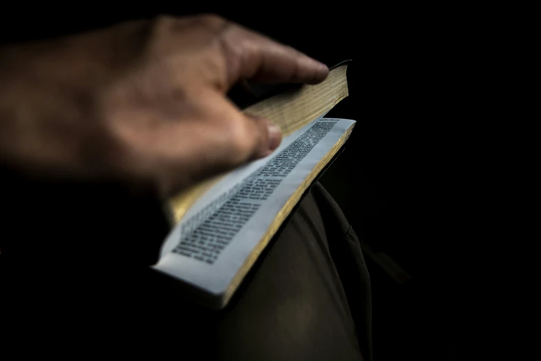 a person's hand on a piece of paper