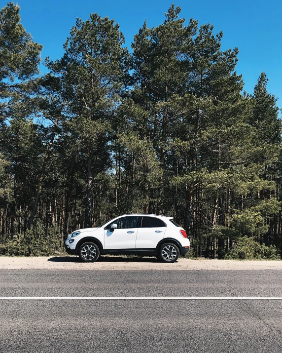 a white suv parked on the side of a street